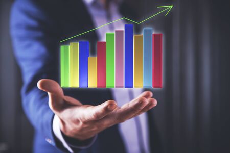 young business man hand holding  graph in screenの写真素材