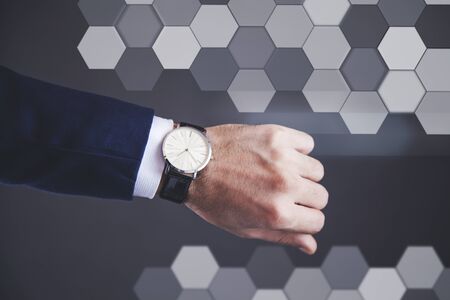 young business man hand watch on abstract backgroundの写真素材