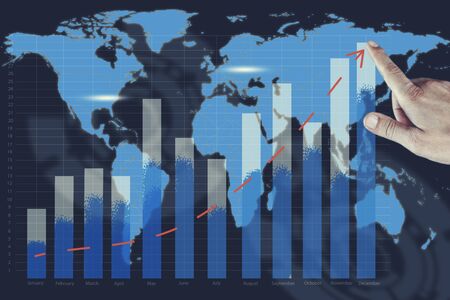 business man hand success graph  in map backgroundの写真素材