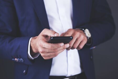 young business man touching in phone screen