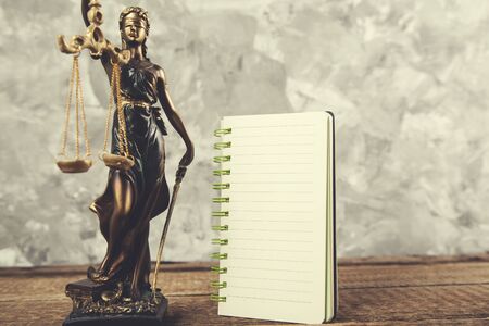 justice lady with notepad on the wooden tableの写真素材