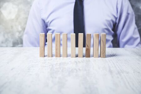 business man hand wooden cubes on the deskの写真素材