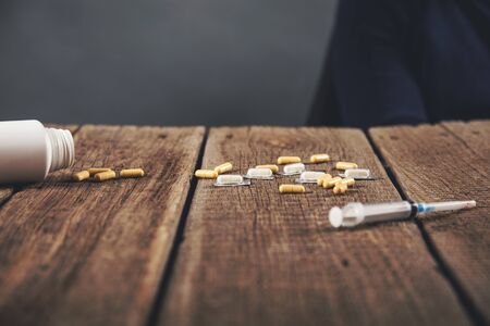 medicine and syringe on the wooden deskの写真素材