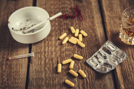 alcohol with drug  and cigarettes  on the desk