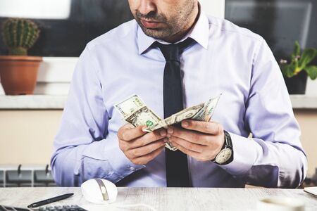 business man hand holding  money on deskの写真素材