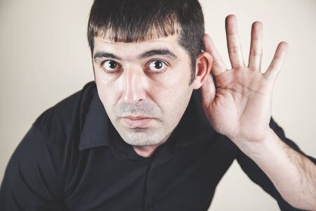 young business man hand in ear on white background