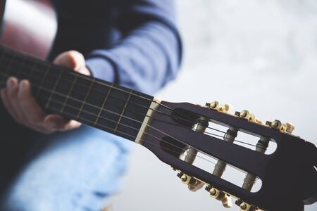 man hand guitar playing the guitar on gray backgroundの写真素材