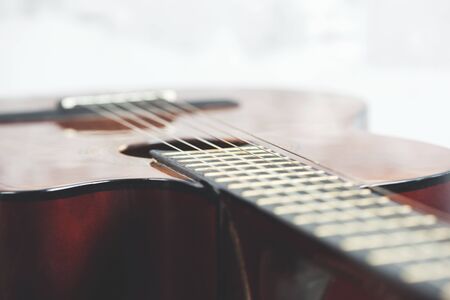 brown guitar on the gray desk backgroundの写真素材