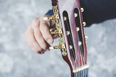 man hand guitar playing the guitar on gray backgroundの写真素材