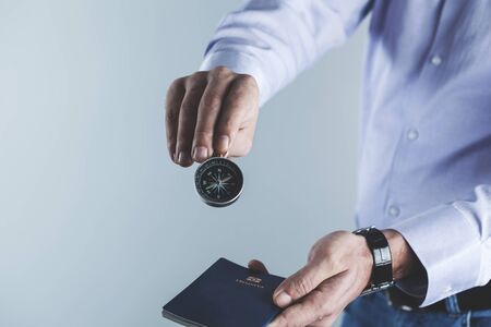 man hand compass with passport on gray backgroundの写真素材