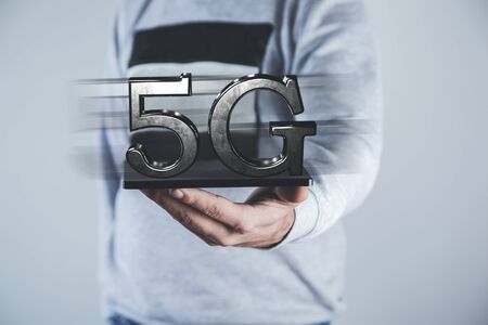 man hand tablet with 5G in screen
