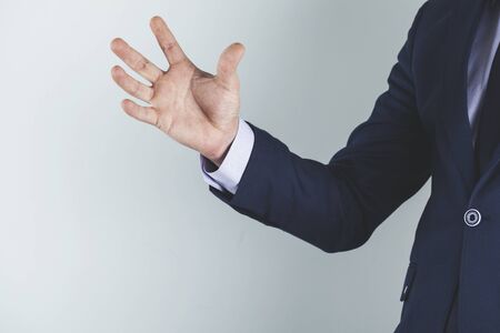 angry business man hand on gray backgroundの写真素材