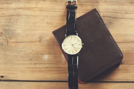 beautiful brown watch on the wallet on deskの写真素材