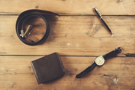 watch with  wallet and belt on the deskの写真素材