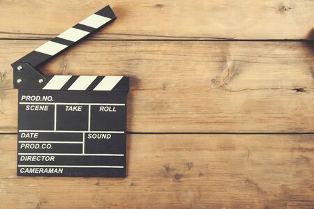 black movie sign on the wooden deskの写真素材