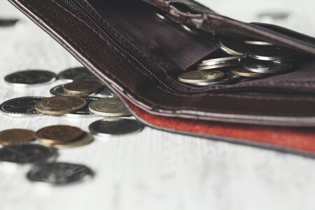 coins on wallet on the wooden table