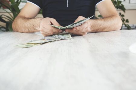 man hand money  on the wooden desk