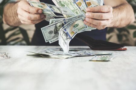 man hand money with wallet on desk