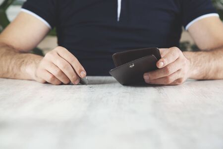 man hand coin with wallet on deskの写真素材