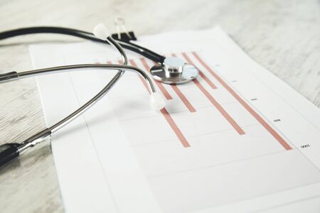 tethoscope on the graph in paper on deskの写真素材