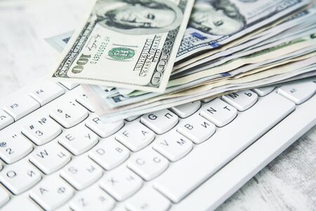 money on keyboard on the wooden deskの写真素材