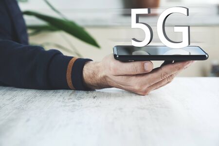 man hand phone with 5G text in screenの写真素材