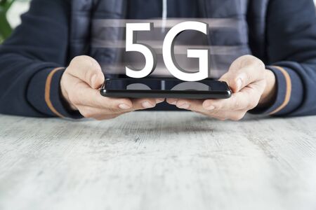 man hand phone with 5G text in screenの写真素材