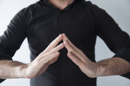 young man making  yoga with hands
