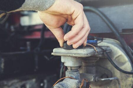 the young worker man hand car oil