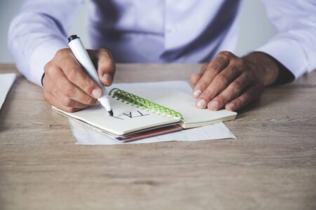man written tax text on notepad on deskの写真素材