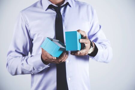 young business man hand holding blue box 