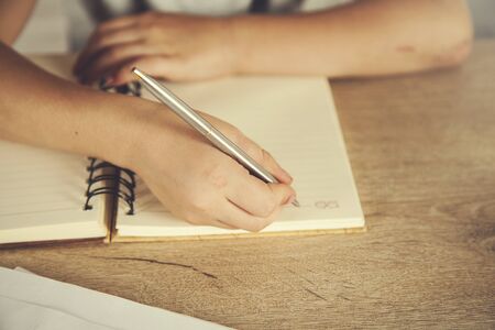 baby hand pen with notepad on the desk
