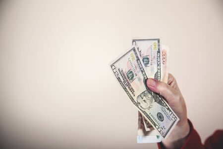 woman hand money on the grey wall background