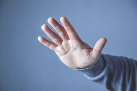 angry man palm on the blue wall background