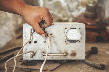 the worker man hand car battery charger の写真素材