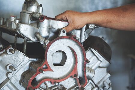 worker man hand car motor in garageの写真素材