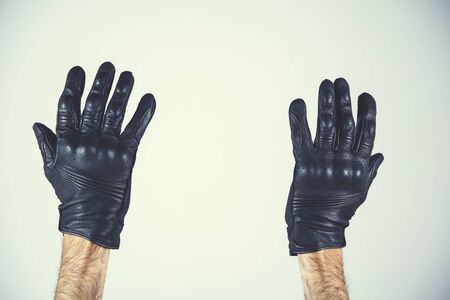 man hand black gloves on gray backgroundの写真素材