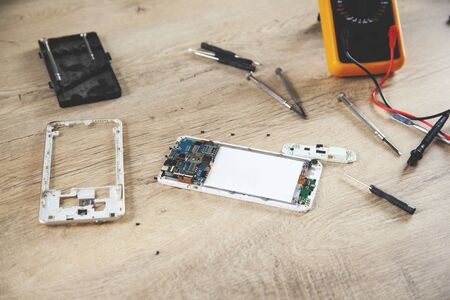 phone with tester on the wooden desk