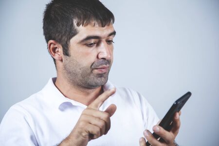 business man  hand smart phone on gray backgroundの写真素材