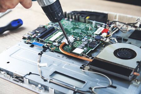 young worker man repair computer on desk