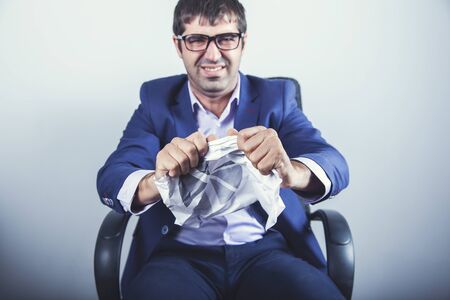 man hand crumpled document in office background
