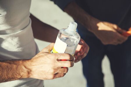worker man hand holding bottle  and  clothの写真素材