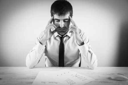 thinking man in the  office desk background
