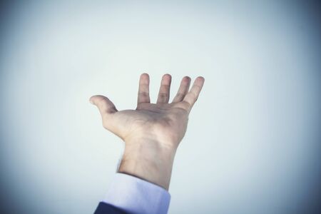 man empty palm on the dark wall backgroundの写真素材