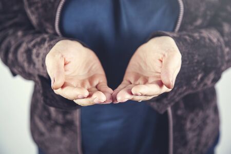woman empty palm on the gray wall background