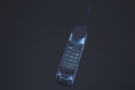 vintage black phone on the black table background