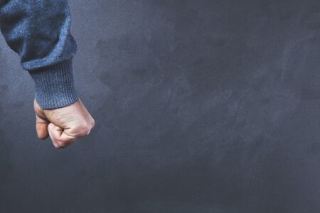 angry man fist on the  gray abckground