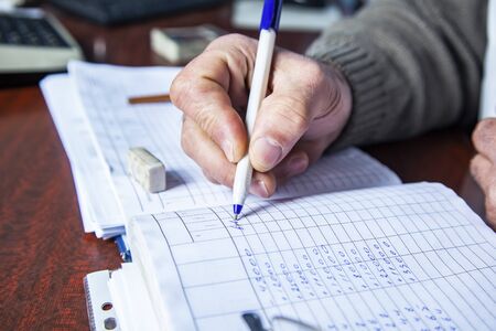 man hand pen with document on the desk