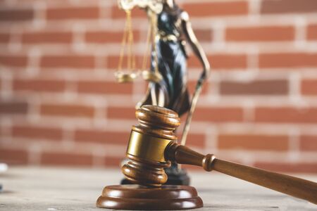 justice lady and judge on the table on brick wall backgroundの写真素材