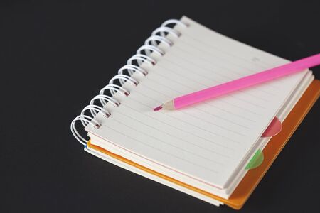 pencil on the open notepad on the table